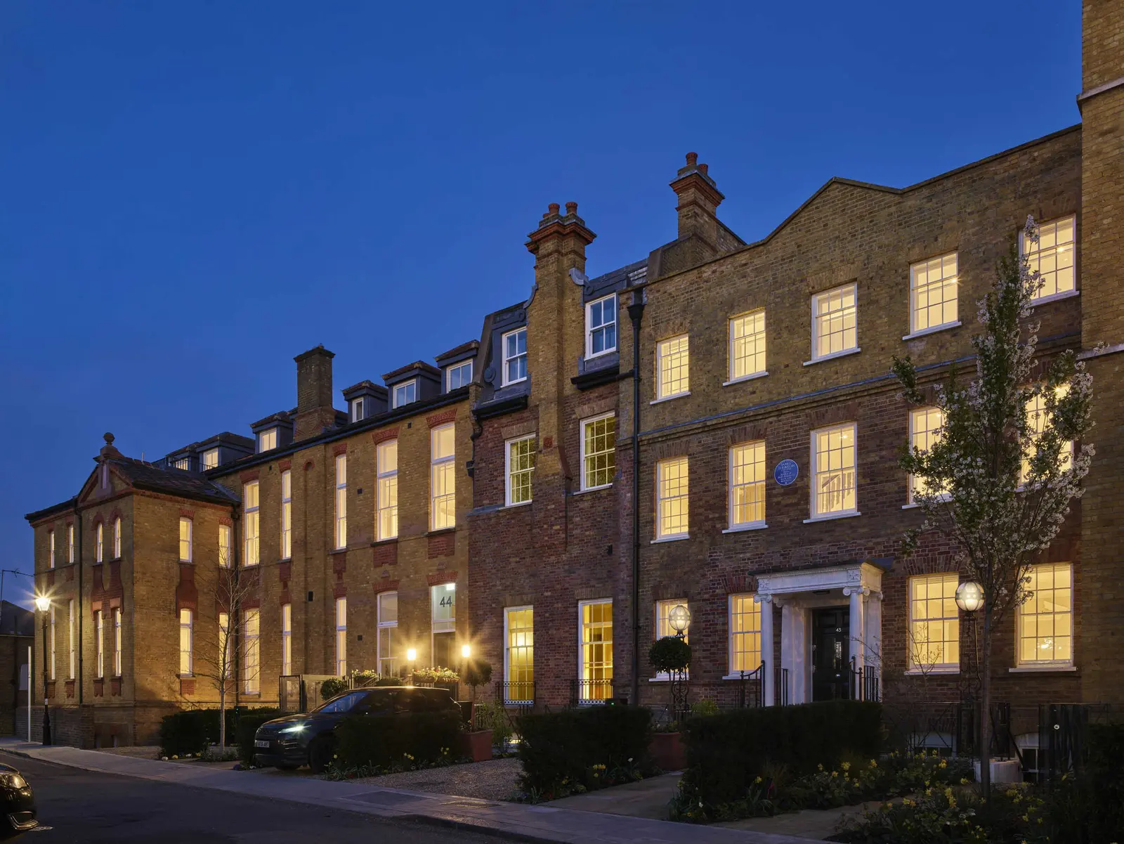 The mixed-use regeneration in SW London, showing the Grade II listed hospital conversion and the central courtyard.